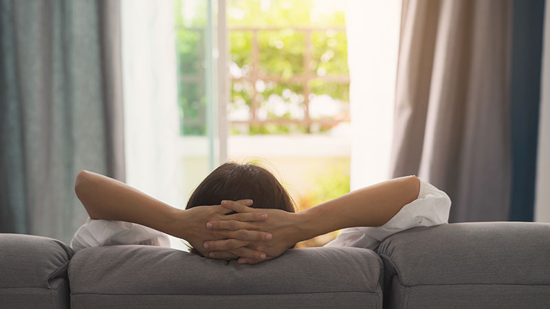 Peaceful Relaxed Person Sitting On Couch